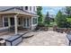 Stone patio features a seating area, lush landscaping, and scenic views for outdoor living and entertaining at 5448 El Diente St, Golden, CO 80403