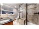 Bathroom with walk-in shower and a vanity with granite countertops at 5448 El Diente St, Golden, CO 80403