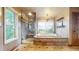 Bright bathroom showcasing a tub and separate tiled shower, accented by natural light at 5448 El Diente St, Golden, CO 80403