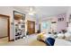 Vaulted bedroom includes closet, shelving, light carpet, and comfortable furniture at 5448 El Diente St, Golden, CO 80403
