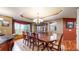 Formal dining room featuring classic wood furniture, a decorative chandelier, and hardwood flooring at 5448 El Diente St, Golden, CO 80403