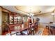 Formal dining room featuring classic wood furniture, a decorative chandelier, and hardwood flooring at 5448 El Diente St, Golden, CO 80403