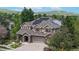 Charming two-story home with lush landscaping, a stone and stucco facade, and solar panels at 5448 El Diente St, Golden, CO 80403