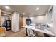 Bright hobby room with sewing machine, crafting table, and ample storage space in a well-lit, comfortable environment at 5448 El Diente St, Golden, CO 80403