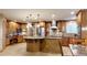 Gourmet kitchen with stainless steel appliances, custom cabinetry, and a large island with pendant lighting at 5448 El Diente St, Golden, CO 80403