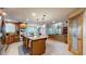 Spacious kitchen with a central island, stainless steel appliances, and a seamless transition to the living room at 5448 El Diente St, Golden, CO 80403