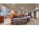Finished living room in basement with fireplace, sofas, and wet bar at 5448 El Diente St, Golden, CO 80403