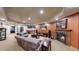 Finished basement living room featuring a fireplace, sofas, and wet bar at 5448 El Diente St, Golden, CO 80403