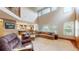 Open living room with a soaring ceiling, large windows, and a seamless transition into the modern kitchen at 5448 El Diente St, Golden, CO 80403