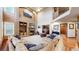 Spacious living room boasts a fireplace, built-in shelves, and a soaring vaulted ceiling, creating an inviting atmosphere at 5448 El Diente St, Golden, CO 80403