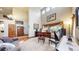 Elegant living room with high ceilings, a grand piano, and comfortable seating at 5448 El Diente St, Golden, CO 80403
