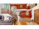 Spacious living room with hardwood floors, an elegant staircase, and a comfortable sofa at 5448 El Diente St, Golden, CO 80403