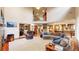 Open-concept living room with soaring ceilings and a view of the upper level, flowing into a modern kitchen space at 5448 El Diente St, Golden, CO 80403