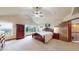 Serene primary bedroom with vaulted ceilings, large windows with view and classic wood furniture at 5448 El Diente St, Golden, CO 80403