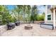 Stone patio boasting a built-in fire pit, grilling area, and lush green surroundings, perfect for outdoor gatherings at 5448 El Diente St, Golden, CO 80403