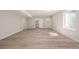 Large open basement with wood-look flooring and recessed lighting at 56159 E Tomahawk Ave, Strasburg, CO 80136