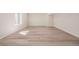 Open basement area with natural light and wood-look flooring at 56159 E Tomahawk Ave, Strasburg, CO 80136