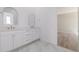 Bathroom featuring double sink vanity and arched mirrors at 56159 E Tomahawk Ave, Strasburg, CO 80136