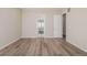 Spacious bedroom with view of the outdoor landscape through the open doorway at 56159 E Tomahawk Ave, Strasburg, CO 80136