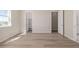 Bedroom featuring hardwood floors, neutral walls, ample closet space, and a view to a walk-in closet and bathroom at 56159 E Tomahawk Ave, Strasburg, CO 80136