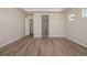 Spacious bedroom with neutral walls, hardwood flooring, ample closet space, and natural light at 56159 E Tomahawk Ave, Strasburg, CO 80136