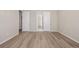 Bright bedroom with wood-look flooring and white trim throughout at 56159 E Tomahawk Ave, Strasburg, CO 80136