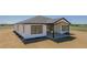 Exterior elevation featuring a white home with a covered patio in a rural setting at 56159 E Tomahawk Ave, Strasburg, CO 80136