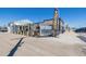 Commercial building with 'The Yard' signage, outdoor seating, and ample parking available at 56159 E Tomahawk Ave, Strasburg, CO 80136