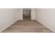 Spacious hallway with wood-look flooring leading to upstairs at 56159 E Tomahawk Ave, Strasburg, CO 80136