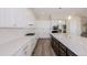 Modern kitchen features sleek white cabinets, quartz countertops, stainless steel appliances, and a stylish island at 56159 E Tomahawk Ave, Strasburg, CO 80136