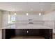 Close up view of kitchen with island, pendant lights and modern countertops at 56159 E Tomahawk Ave, Strasburg, CO 80136