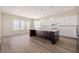 Spacious kitchen features large island, quartz countertops, and stainless steel appliances at 56159 E Tomahawk Ave, Strasburg, CO 80136
