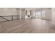 Bright living room features hardwood floors, large windows, and a stylish fireplace at 56159 E Tomahawk Ave, Strasburg, CO 80136