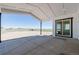 Covered patio area with open view of the surrounding land and clear sky at 56159 E Tomahawk Ave, Strasburg, CO 80136