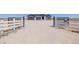 Wide shot of property's gate leading up to home with open rural landscape at 56159 E Tomahawk Ave, Strasburg, CO 80136