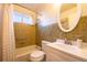 Cozy bathroom featuring a tub/shower combo, a white vanity, and classic tile work at 971 Elm Pl, Thornton, CO 80229