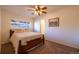 Welcoming bedroom with a queen bed, plush carpet, and a window offering natural light and outdoor views at 971 Elm Pl, Thornton, CO 80229