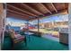 Relaxing covered patio with outdoor seating, perfect for enjoying the backyard view at 971 Elm Pl, Thornton, CO 80229