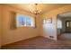 Sunlit dining area with chandelier; neutral walls and plush carpeting offers a versatile space at 971 Elm Pl, Thornton, CO 80229