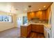 Updated kitchen with wood cabinets, stone countertops, and a chandelier lit dining area at 971 Elm Pl, Thornton, CO 80229