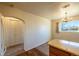 Kitchen area with white appliances, arched doorway, and an adjacent dining area with a chandelier at 971 Elm Pl, Thornton, CO 80229
