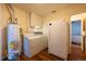 Laundry room featuring a new washer, dryer, water heater, and refrigerator at 971 Elm Pl, Thornton, CO 80229