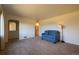 Cozy living room showcasing a blue sofa, neutral carpeting, and ample natural light at 971 Elm Pl, Thornton, CO 80229