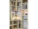 Close-up view of built-in shelving with stylish decor and a cozy reading lamp at 2992 Hooker St, Denver, CO 80211