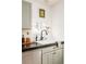 Bright kitchen featuring a white farmhouse sink, black faucet, and neutral cabinets at 2992 Hooker St, Denver, CO 80211