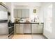 Efficient kitchen with sleek, sage cabinets, a stainless steel dishwasher and modern fixtures at 2992 Hooker St, Denver, CO 80211