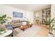 Bright living room featuring hardwood floors, a decorative fireplace and an accent bookcase at 2992 Hooker St, Denver, CO 80211