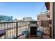 A cozy balcony offers city views with a grill and planters creating an urban oasis at 1801 Wynkoop St # 518, Denver, CO 80202