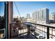 A scenic balcony with a table and stools offers a view of the cityscape, creating an inviting outdoor space at 1801 Wynkoop St # 518, Denver, CO 80202