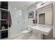 An elegant bathroom features a glass-enclosed shower, pedestal sink, and hexagon tile flooring at 1801 Wynkoop St # 518, Denver, CO 80202
